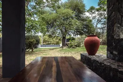 a vase sitting on top of a wooden table at El Refugio Apart in Villa Serranita