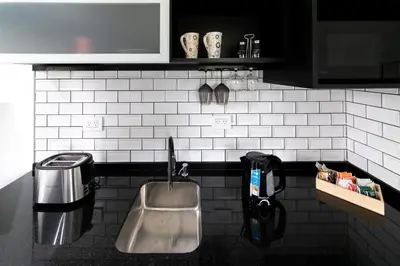 a kitchen counter with a sink and a sink at El Refugio Apart in Villa Serranita