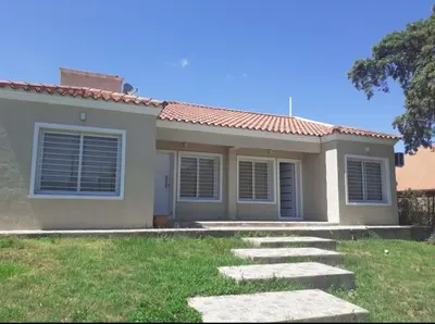 a house with a pathway in front of it at Departamentos Vila in Mina Clavero