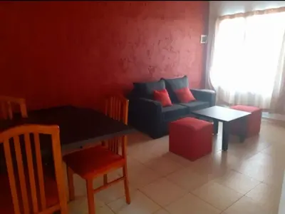 a living room with a couch and a table at Departamentos Vila in Mina Clavero