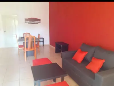 a living room with a couch and a table at Departamentos Vila in Mina Clavero