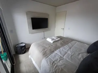 a bedroom with a bed and a flat screen tv at SERIETÁ 1 dormitorio con pileta y terraza in Cordoba