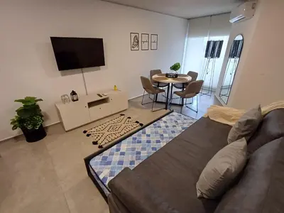 a living room with a couch and a table at SERIETÁ 1 dormitorio con pileta y terraza in Cordoba