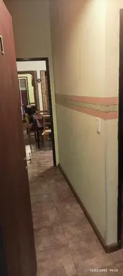 a hallway of a room with a door and a table at Casa de Campo Mama Lucia in Villa Anizacate