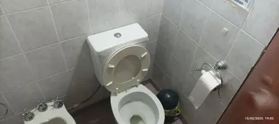 a bathroom with a white toilet in a stall at Casa de Campo Mama Lucia in Villa Anizacate