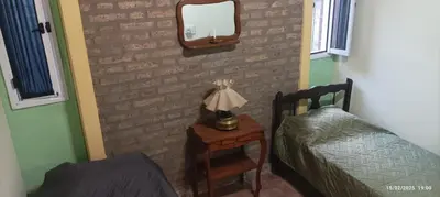 a bedroom with a bed and a mirror on a wall at Casa de Campo Mama Lucia in Villa Anizacate