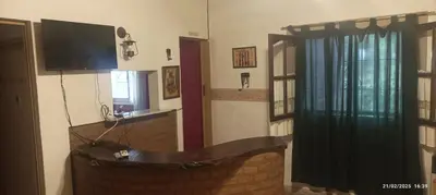 a living room with a flat screen tv and a window at Casa de Campo Mama Lucia in Villa Anizacate