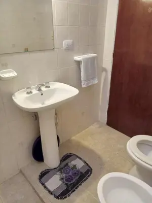 a bathroom with a sink and a toilet and a shower at La Tata in Alta Gracia