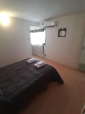 a bedroom with a bed with two towels on it at Meraki Classic in Villa Carlos Paz
