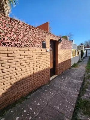 a brick wall with a door on the side of it at Meraki Classic in Villa Carlos Paz