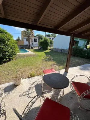 a table and chairs sitting on a patio at Casa en Potrero de Garay con pileta a 100mt Rio San Pedro in Potrero de Garay