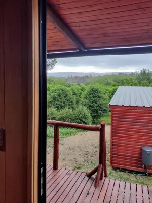 a view of a deck with a red shed at Refugios del Monte in Villa Yacanto