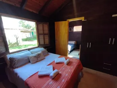 a bedroom with a bed with two towels on it at La Cabañita Córdoba in Villa Rumipal