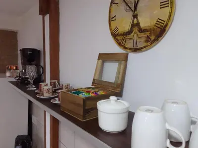 a clock on the wall next to a counter with a clock at El Elyon Duplex in Santa Rosa de Calamuchita
