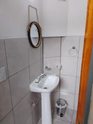 a bathroom with a white sink and a mirror at El Elyon Duplex in Santa Rosa de Calamuchita