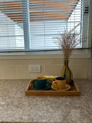 a tray with two cups and a vase on a counter at Casa YO in Cordoba