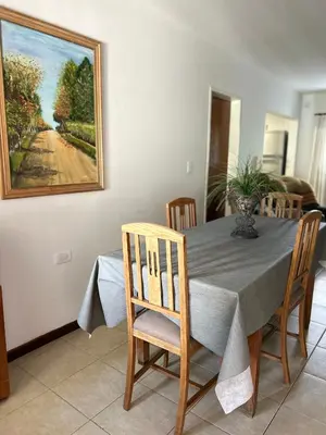 a dining room table with a painting on the wall at Casa YO in Cordoba