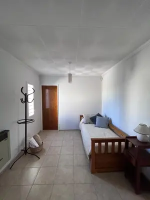a bedroom with a bed in a white room at Casa YO in Cordoba