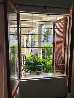 a window with a view of a balcony with plants at Casa YO in Cordoba