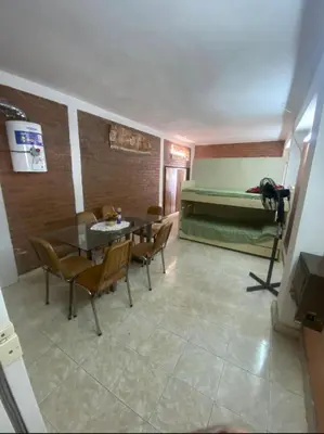 a room with a table and chairs and a bed at Lo de Alicia 1 in Estancia Vieja