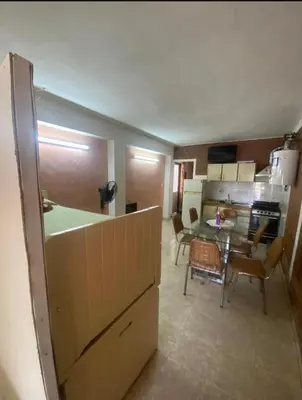 a kitchen and dining room with a table and chairs at Lo de Alicia 1 in Estancia Vieja