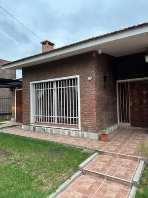 a brick house with a window with bars on it at Casa en Villa Carlos Paz in Villa Carlos Paz