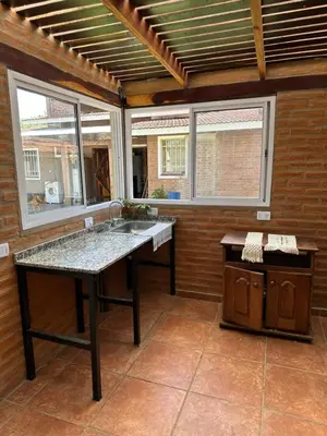 a kitchen with a table and a sink at Casa en Villa Carlos Paz in Villa Carlos Paz