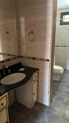 a bathroom with a sink and a toilet at Casa en Villa Carlos Paz in Villa Carlos Paz