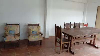 a dining room with a wooden table and chairs at Casa en Villa Carlos Paz in Villa Carlos Paz