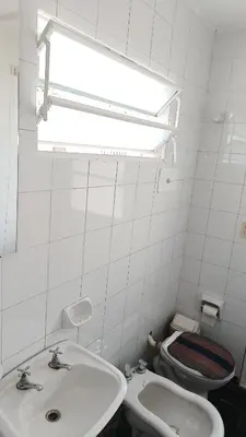 a white bathroom with a sink and a toilet at Departamento para 2 personas in Bialet Massé