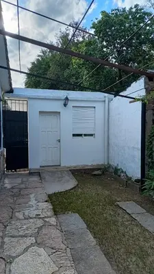a white garage with a window and a door at Departamento para 2 personas in Bialet Massé