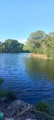 a body of water with trees in the background at Departamento para 2 personas in Bialet Massé