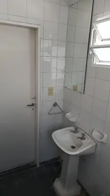 a white bathroom with a sink and a shower at Departamento para 2 personas in Bialet Massé