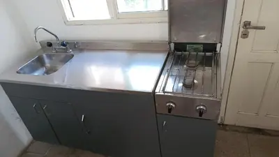 a kitchen with a stainless steel sink and a window at Departamento para 2 personas in Bialet Massé