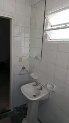 a white bathroom with a sink and a window at Departamento para 2 personas in Bialet Massé