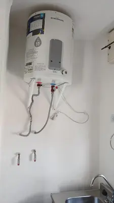 a box is hanging on a wall above a sink at Departamento para 2 personas in Bialet Massé