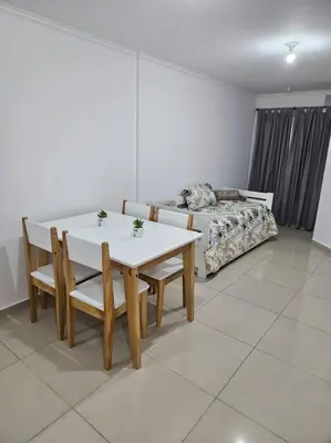 a living room with a table and chairs and a bed at Departamento en Córdoba in Cordoba