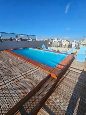 a swimming pool on the roof of a building at Departamento en Córdoba in Cordoba