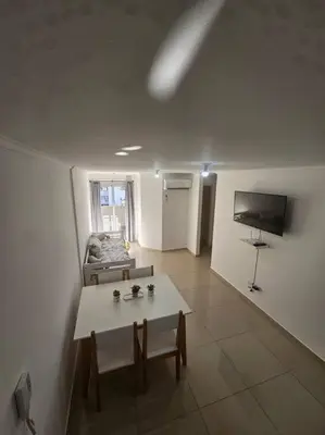 a living room with a table and a couch at Departamento en Córdoba in Cordoba