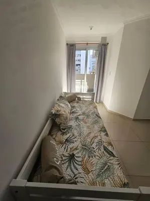a bed in the corner of a room at Departamento en Córdoba in Cordoba