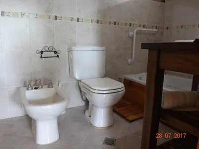 a bathroom with a toilet and a sink at Cabañas & Suites 