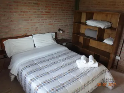 a bedroom with a bed with towels on it at Cabañas & Suites 