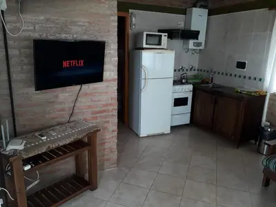 a kitchen with a white refrigerator and a microwave at Cabañas & Suites 