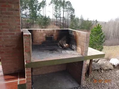 a brick oven with a fire inside of it at Cabañas & Suites 