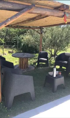 a group of chairs and a table under a gazebo at Cuatro Elementos Housing in Villa Parque Siquiman