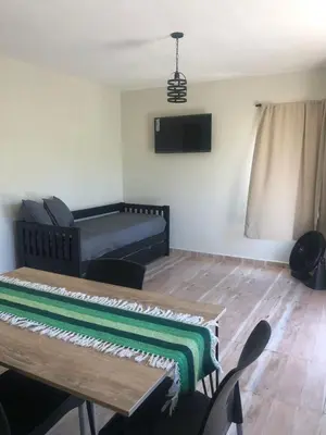 a living room with a table and a couch at Cuatro Elementos Housing in Villa Parque Siquiman