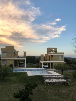 a large house with a swimming pool in front of it at Cuatro Elementos Housing in Villa Parque Siquiman