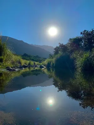a view of a river with the moon in the sky at Cabañas San Miguel in Cortaderas