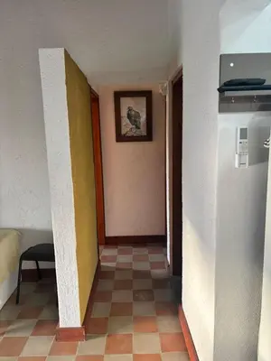 an empty hallway with a room with a refrigerator at Cabañas Dos Soles in Cordoba