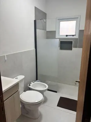 a bathroom with a toilet and a sink and a shower at Cabañas Dos Soles in Cordoba